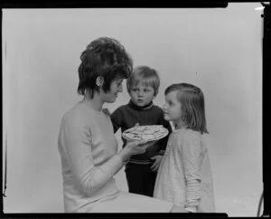 Woman and two children with crackers on a plate