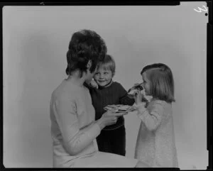 Woman and two children with crackers on a plate