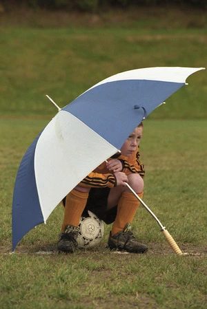 Island Bay Stingrays striker Roddy Brown sitting under an umbrella, Wellington - Photograph taken by Phil Reid