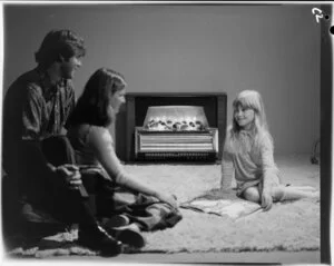 Family in front of Magicoal heater