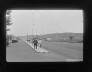 Two people on a traffic island