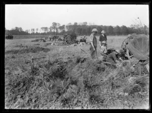 NZ 18 pounder in action, gun position camouflaged, near Le Quesnoy