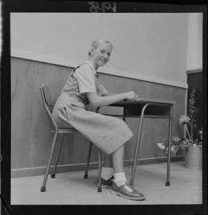 Unidentified student seated at a desk, on the opening day of Onslow College, Johnsonville, Wellington