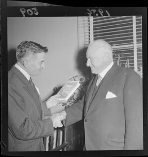 Mr Robert Macalister, Mayor of [Wellington?], [(right?] presenting Mr G H A Swan, President of the Wellington Junior Chamber of Commerce, with a book entitled, The Merchants Paved the Way