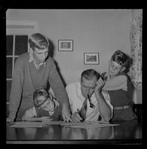 Mr M A Watts with his sons filling in census forms