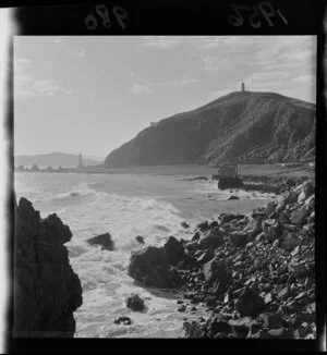 View of Pencarrow Head and lighthouse, with sewage pipes on the beach waiting to be installed