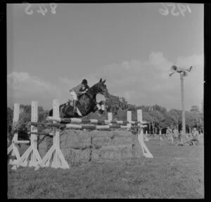 Miss Susan Dodds and her horse leaping hurdles at Trentham