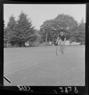 Unidentified male cyclist at an athletics event, Maidstone Park, Upper Hutt