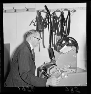 Unidentified man viewing frames of a film at the Film Censor's Office