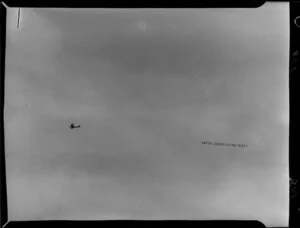 Banner with words 'Enter ladies flying test' being flown around Wellington by the Wellington Aero Club