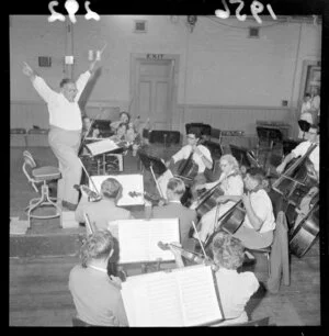 Conductor Selwyn Toogood leads a National Orchestra rehersal, with musicians including cellists, double-bassists, violinists and viola players