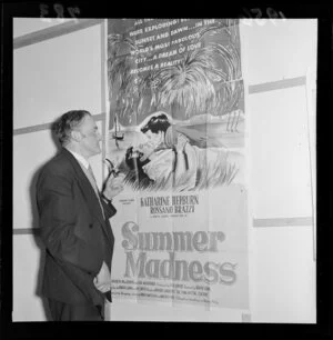 Gordon Mirams looking at a poster advertising 'Summer Madness' in the Film Censor's Office