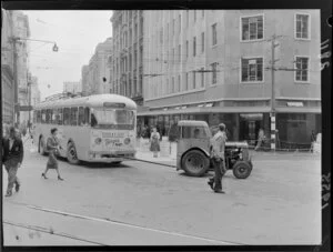 A tractor towing a trolley bus around the corner of Featherston Street and Hunter Street, Wellington