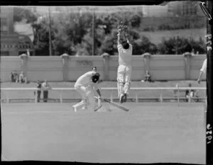 Cricket match between Wellington and the West Indies at the Basin Reserve, featuring the Wellington batsman ducking and the West Indian wicket keeper jumping toward the ball