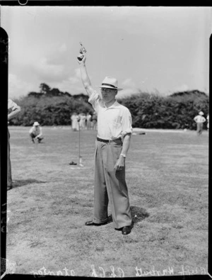 Starter Cliff Harbutt with his pistol in the air, 1950 British Empire Games