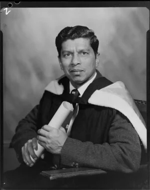 Fernandez, man in academic gown with diploma