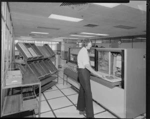 Man operating large computer