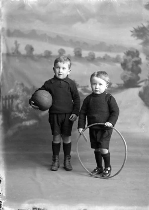 Two young boys with a hoop and a ball