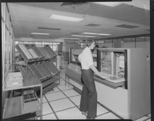 Man operating large computer