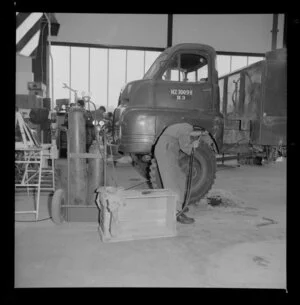 Man fixing truck, Royal Electrical and Mechanical Engineers workshop, Waiouru military camp