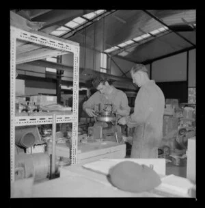 Two men fixing a motor, Royal Electrical and Mechanical Engineers workshop, Waiouru military camp