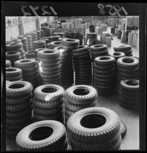 Interior of Dunlop rubber factory, Upper Hutt, showing stacks of tyres