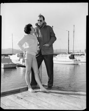 Man & woman modelling Silverdale pullovers on jetty