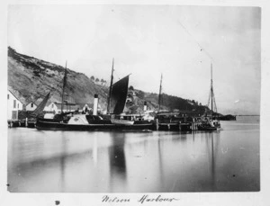 Scene at a wharf in Nelson Harbour showing a paddle steamer and other vessels