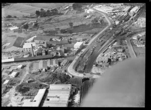 View of the Australian Glass Company with Great South Road and Penrose Railway Station with yards, Auckland