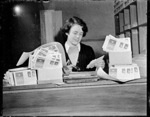 Woman at post office counter with health stamps