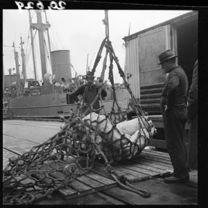 Loading meat for Allied Forces in the Pacific, on to a YP cargo boat at an Auckland wharf