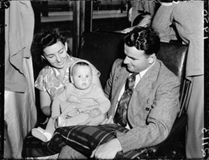 Man, woman and baby on a train at Wellington Railway Station just before the railway strike