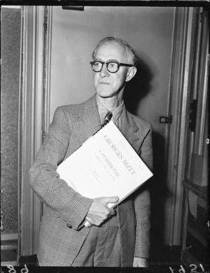 Man holding a score of a Bizet symphony