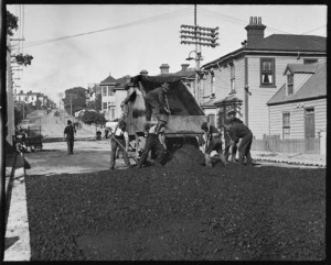 Men laying tar during the construction of a road, Wellington