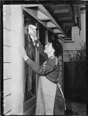 Girl Guide cleaning a window