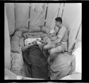 General Bernard Freyberg lying injured in a trench at Minqar Qaim, Egypt - Photograph taken by Harold Paton