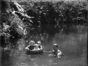 Man and children swimming in a river, Northland