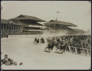 Large crowd in two grandstands watching trotting at Addington Raceway, Christchurch