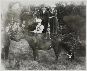 Group portrait of a family riding a horse