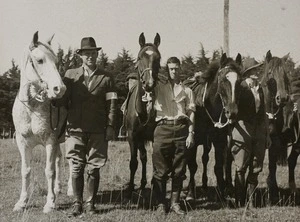 Four riders pose with their horses
