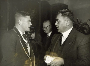 South African rugby player for the Springboks, Chris de Wilzem, talking to Ralph Love, Maori rugby selector, at a reception in Wellington