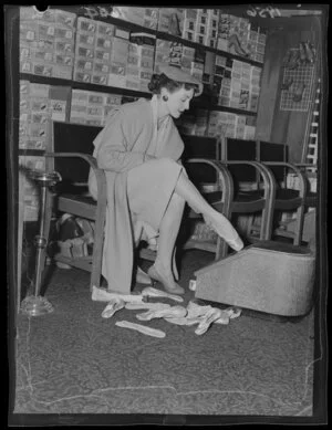 Dancer Pat Penrose, star of the Peep Show (the Oomph Girl), trying on ballet shoes