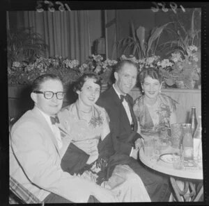 Two unidentified couples at their table at the Hutt Valley A & P Society Ball, Taita Hall, Lower Hutt