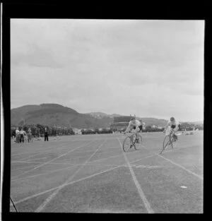 Athletic meeting, two cyclists, Petone Recreation Grounds, Wellington
