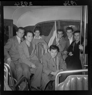 Group of Hungarian refugees, young men with the Hungarian flag, in a bus, Wellington