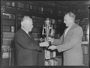 Labour Party leader Walter Nash handing a trophy to Major P G Monk, president of the Hutt Valley Cricket Association