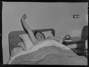 Dancer Pat Penrose, star of the Peep Show (the Oomph Girl), waking up in her bed