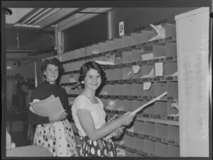 Two unidentified women students, sorting Christmas mail, Chief Post Office, Wellington