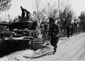Infantry passing a wrecked German Tiger tank, Italy