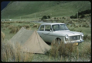 Austin A40 car parked beside a small tent, Wairarapa